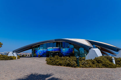 Modern building with curved design under a clear blue sky